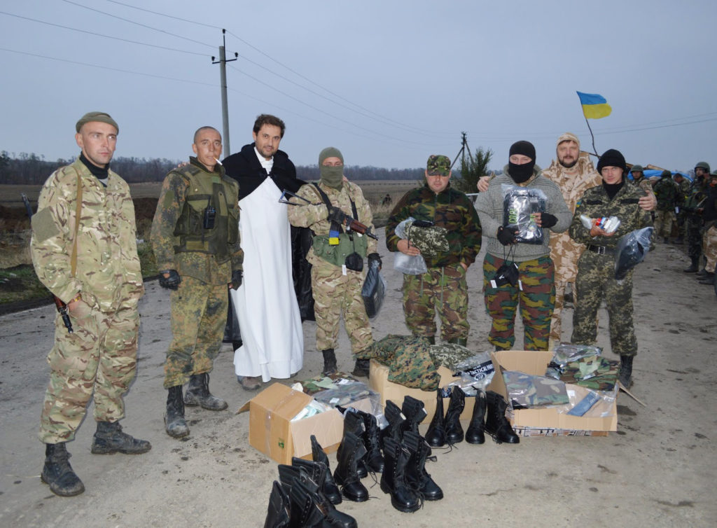 Fr. Leonard Aduszkiewicz, pastor of Our Lady of Czestochowa Parish in Mariupol, Ukraine, poses with Ukrainian soldiers at a checkpoint near the city in this September 2014 photo. (CNS photo/courtesy Mariana Karapinka) 