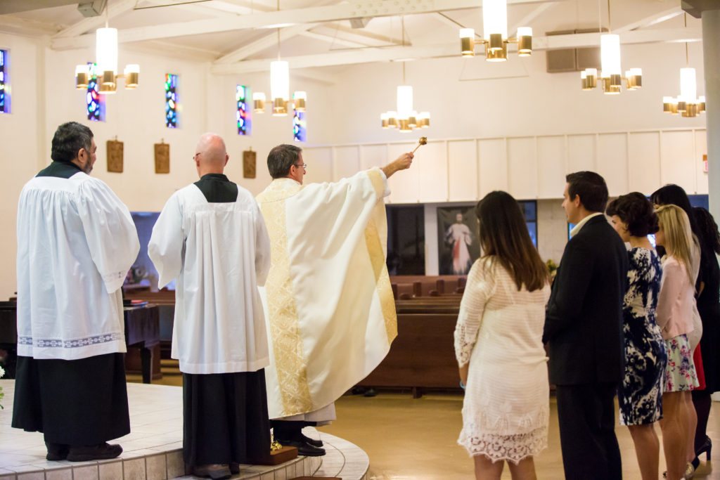 Father Dan Vanyo, parochial vicar of Queen of Peace Parish in Mesa and chaplain for Benedictine University at Mesa, blesses the graduates at the Baccaelaurate Mass held at Queen of Peace before their graduation ceremony May 16. )Courtesy Benedictine University at Mesa)
