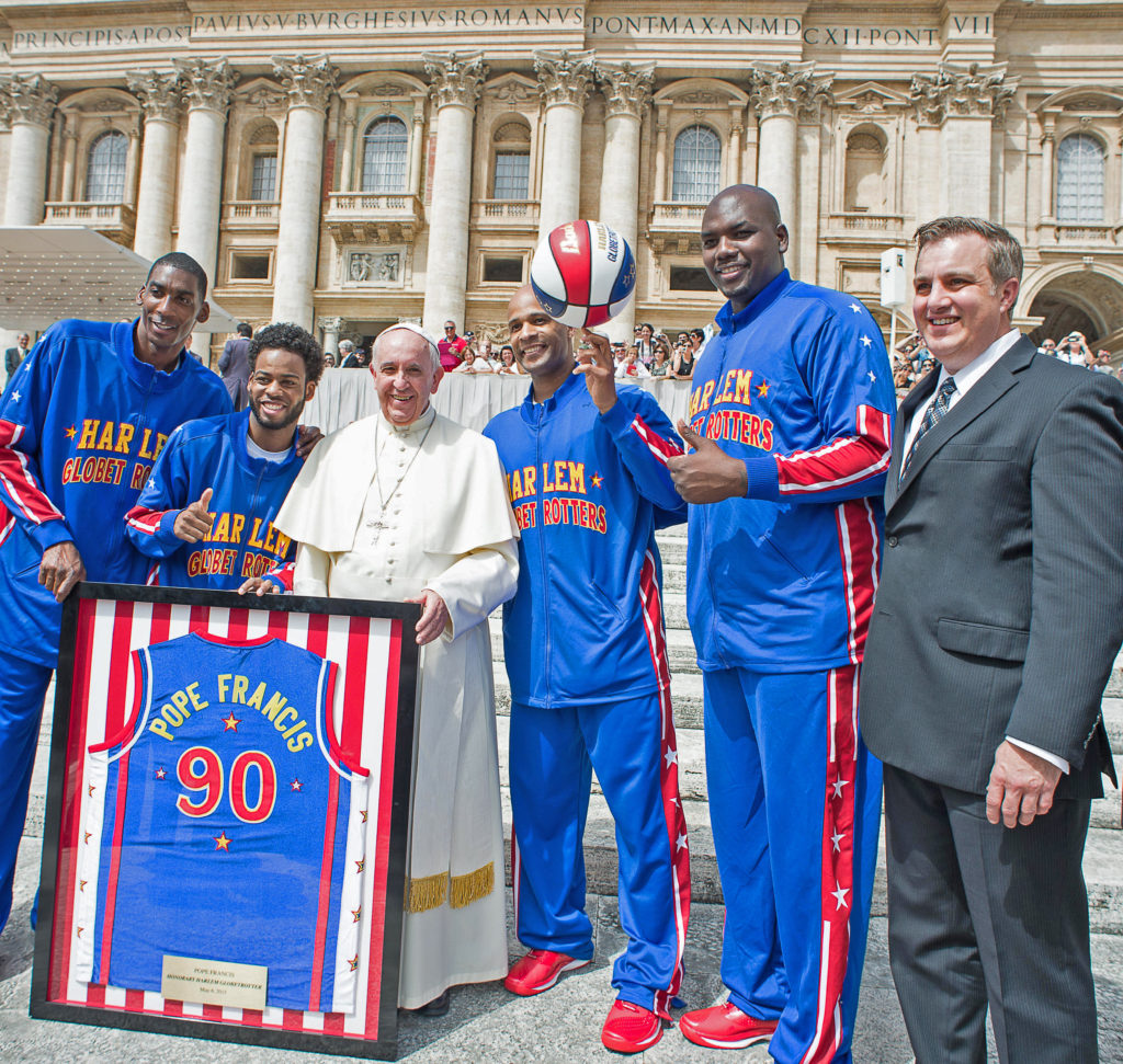 Brett Meister, right, coordinated the May 6 meeting between the Phoenix-based Harlem Globetrotters and Pope Francis in Vatican Square. Meister, a Christ the King parishioner, coordinated a similar trip in 2000 to name Pope John Paul II an honorary team member. (L'Osservatore Romano)
