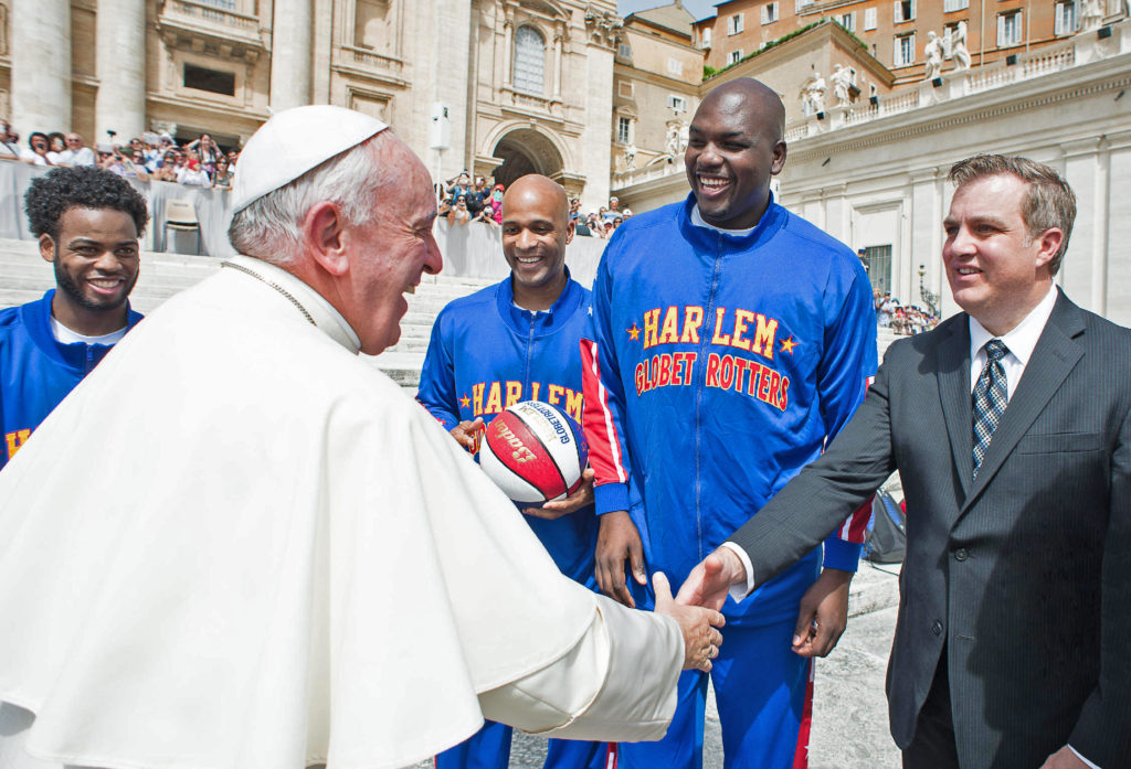 Brett Meister, greets Pope Francis in Vatican Square May 6. He coordinated the encounter with the Phoenix-based Harlem Globetrotters, in which the team named him the ninth honorary team member in its 90-year history. (L'Osservatore Romano)
