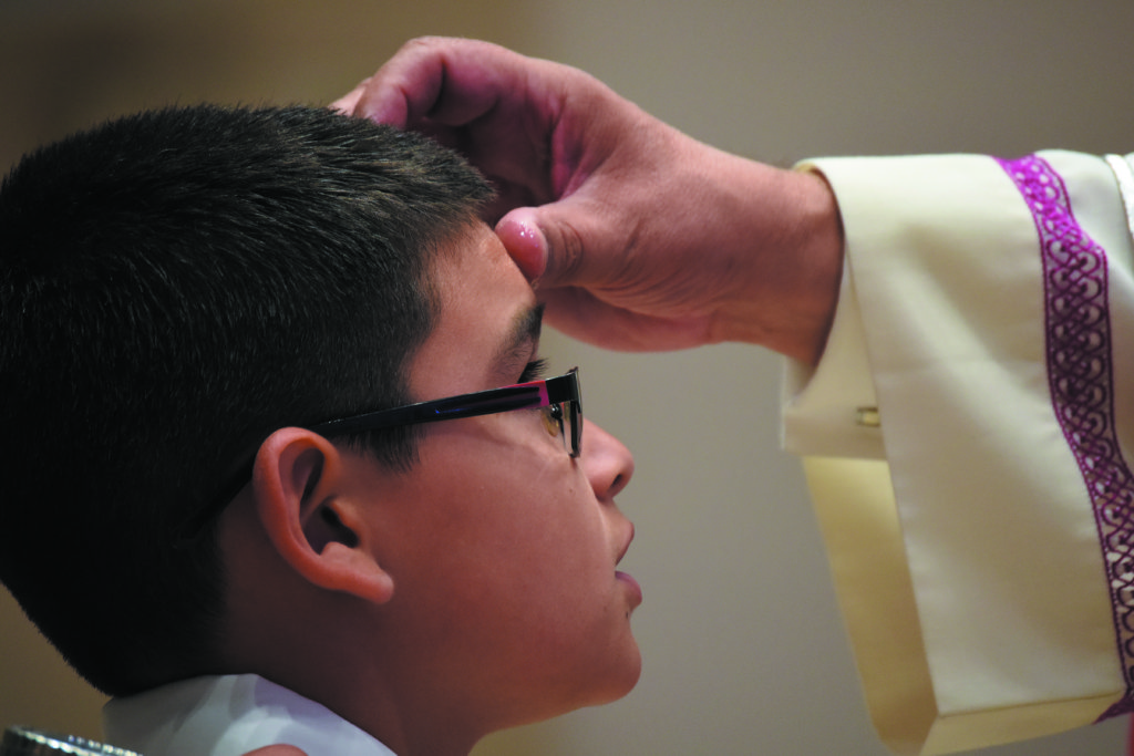 Bishop Eduardo A. Nevares confirms a young parishioner at Immaculate Heart of Mary May 13. (Tamara Tirado/CATHOLIC SUN)