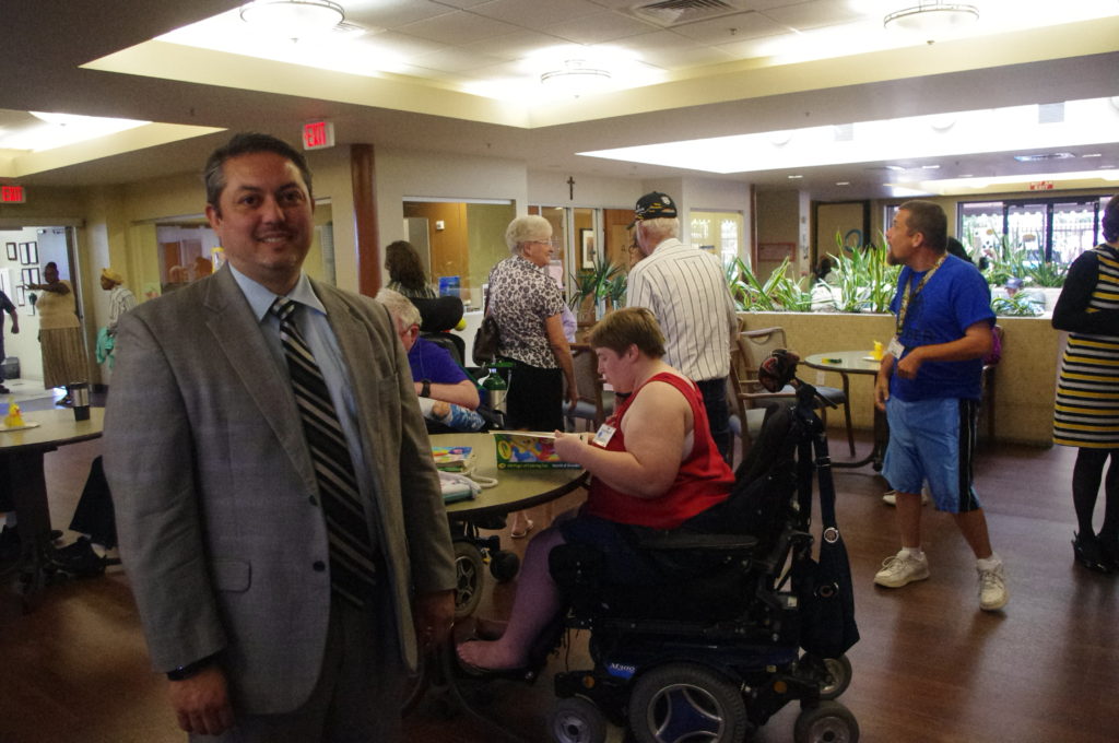 Tom Egan, seen here with clients at the Monsignor Edward J. Ryle Adult Day Health Center April 22, became the new CEO and president of Foundation for Senior Living in January. (Joyce Coronel/CATHOLIC SUN)