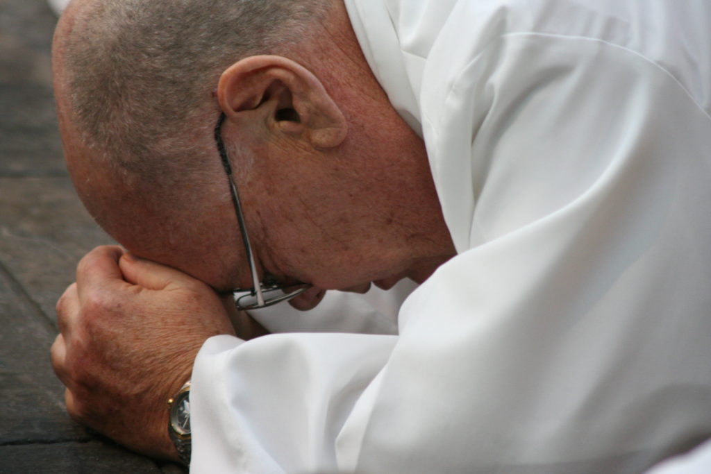 Deacon Bob Palmer lies prostrate during his 2006 ordination as a way of symbolically laying down his life for the Church. (Catholic Sun file photo)