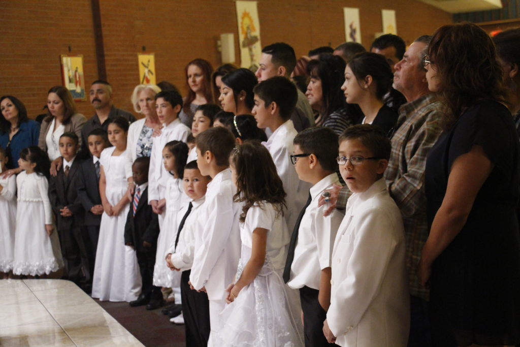 Twenty students across the grades make their first baptismal promises during a school Mass at Our Lady of Perpetual Help in Glendale April 16. (Ambria Hammel/CATHOLIC SUN)