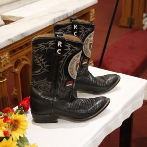 The late governors boots, emblazoned with the Arizona Seal, are placed at the front of the church during the funeral.