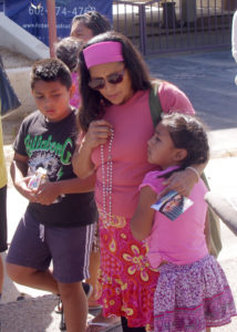 A mother prays the Rosary with her children at the May 22 event. 