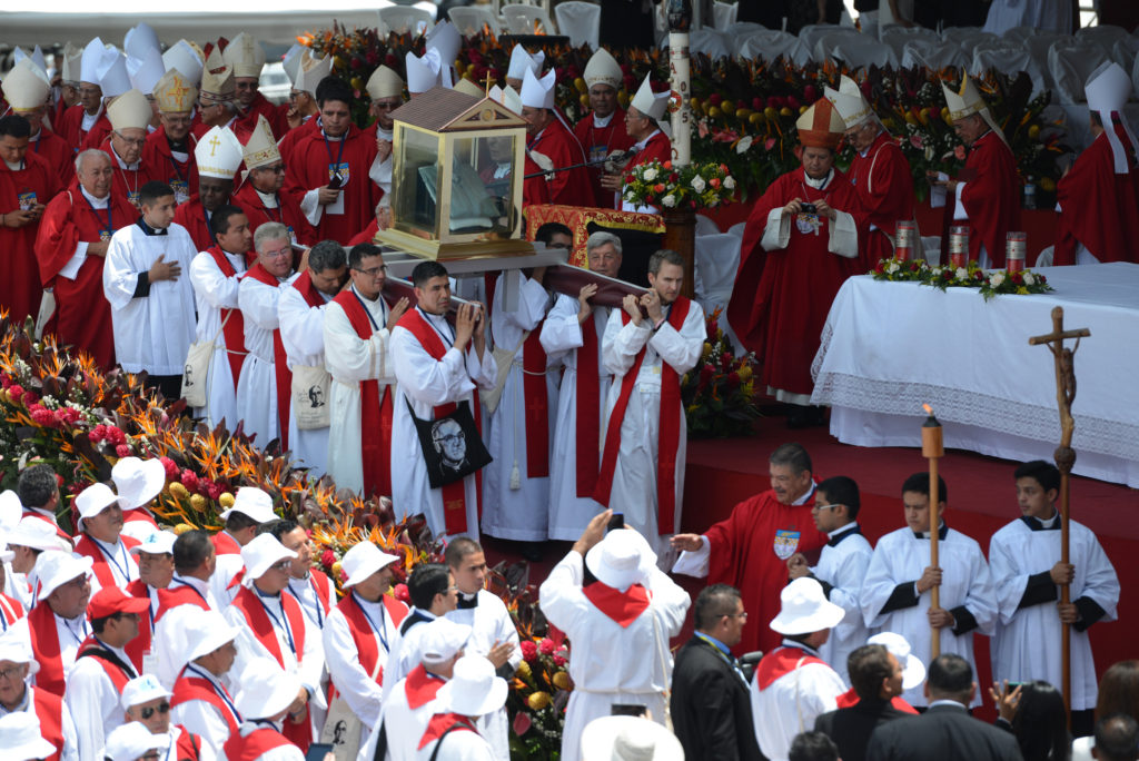 Priests carry the blood-stained shirt of Archbishop Oscar Romero during his beatification Mass at the Divine Savior of the World square in San Salvador May 23. (CNS photo/Lissette Lemus) 