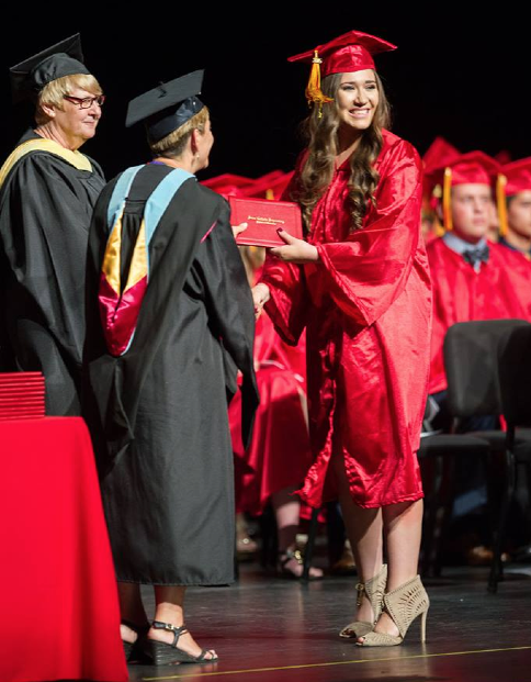 A Seton Catholic Preparatory graduate receives her diploma from MaryBeth Mueller, superintendent for the Diocese of Phoenix May ##. (photo courtesy of )