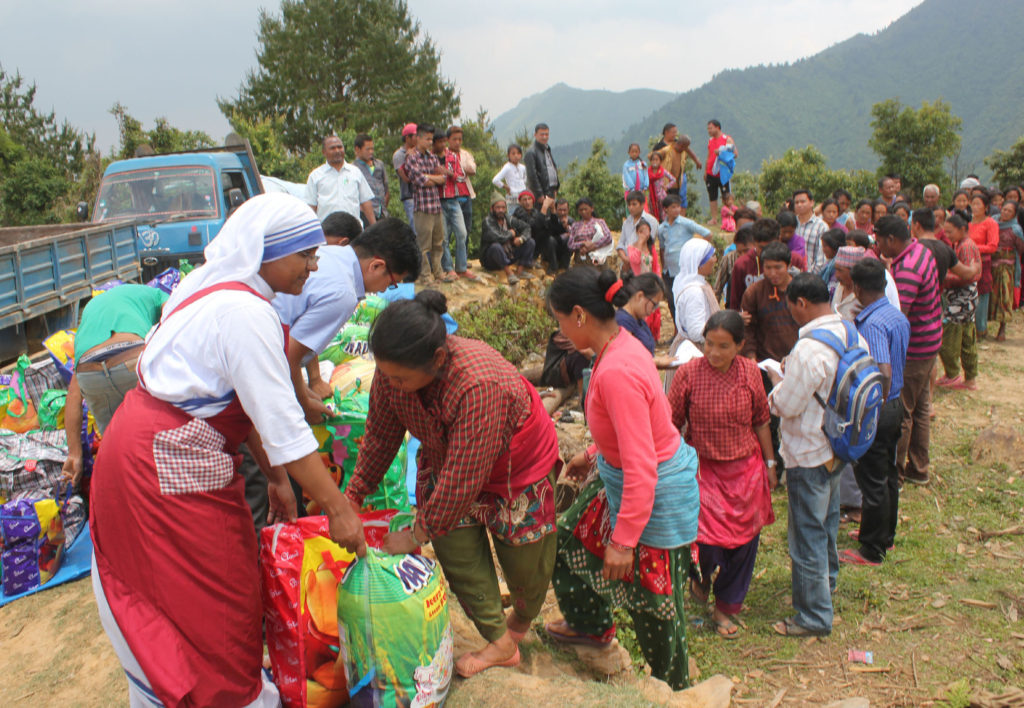 A member of the Missionaries of Charity helps distribute relief items to earthquake victims May 16  in the mountains overlooking Kathmandu Valley in Nepal. (CNS photo/Anto Akkara)
