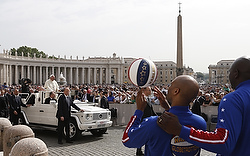 Members of the Harlem Globetrotters watch as Pope Francis arrives to lead his general audience in St. Peter's Square at the Vatican May 6. (CNS photo/Paul Haring) 