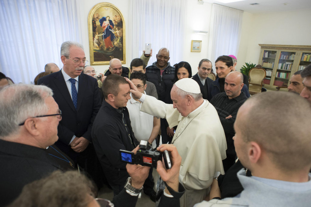 Pope Francis blesses prisoners from Pisa and Pianosa jails during a private meeting at the Vatican in this Feb.19, 2014, file photo. The pope regularly visits with prisoners, a practice he began while archbishop of Buenos Aires. (CNS photo/L'Osservatore Romano via Reuters) 