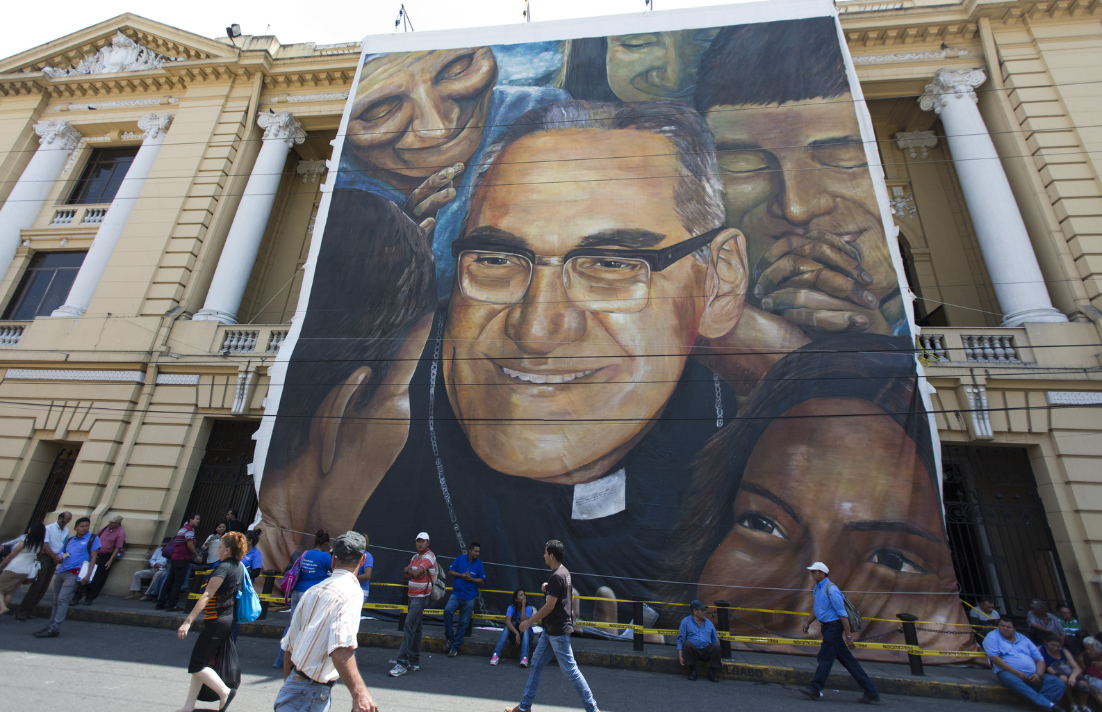 A large canvas depicting Archbishop Oscar Romero hangs on the facade of the National Theater in San Salvador, El Salvador, March 24. A small copy of this painting was given to Pope Francis by the president of El Salvador. The archbishop was fatally shot as he celebrated Mass March 24, 1980. (CNS photo/Octavio Duran) 