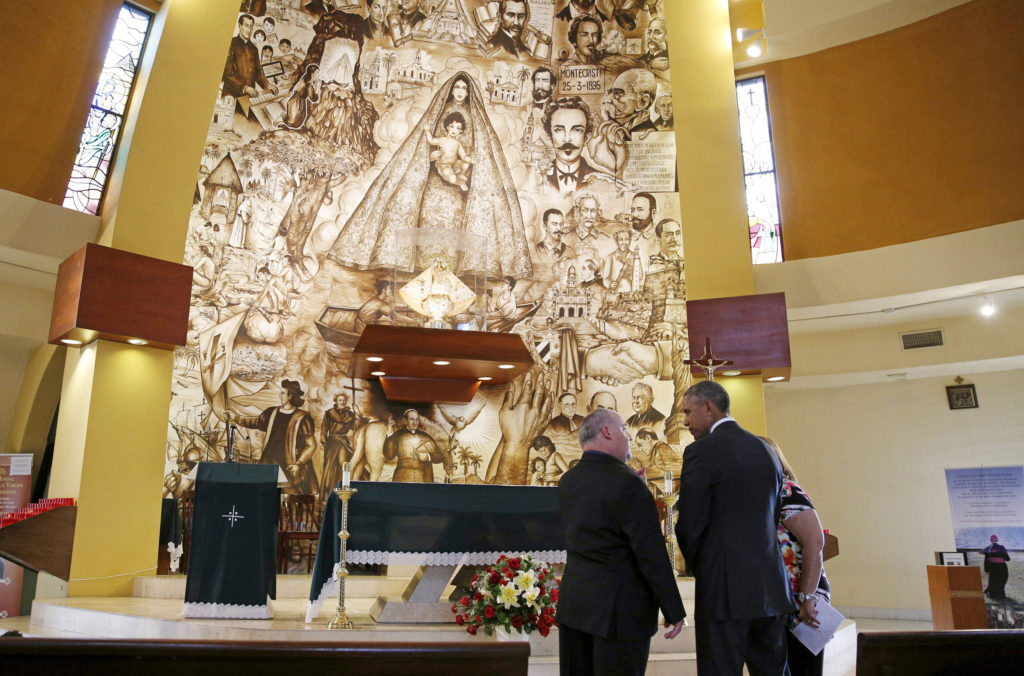 U.S. President Barack Obama makes an unannounced stop to the Shrine of Our Lady of Charity in Miami May 28.  Standing with the president is Father Juan Rumin Dominguez. The shrine is named for the patroness of Cuba and the Cuban people. (CNS photo/Kevin Lamarque, Reuters) 
