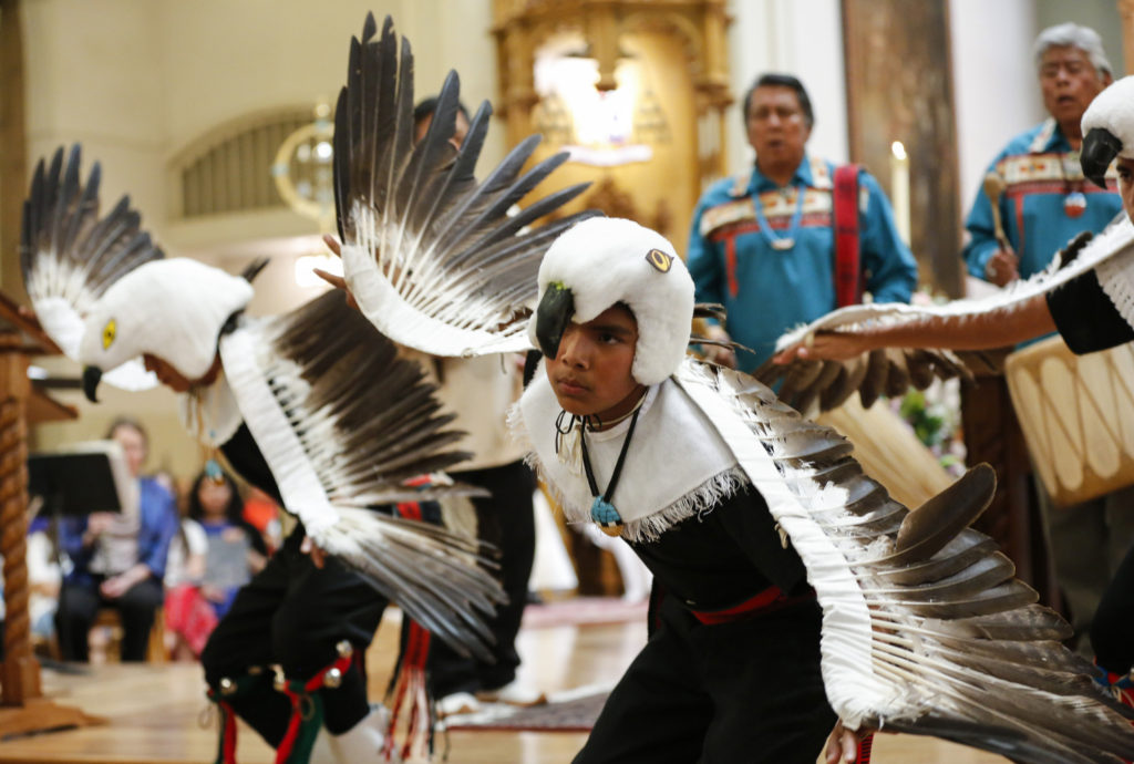 Young men offer the Eagle Dance following Communion during the Mass of installation for Archbishop John C. Wester at the Cathedral Basilica of St. Francis of Assisi in Santa Fe, N.M., June 4. The Pueblo dance is an offering of praise and exaltation directed to God.