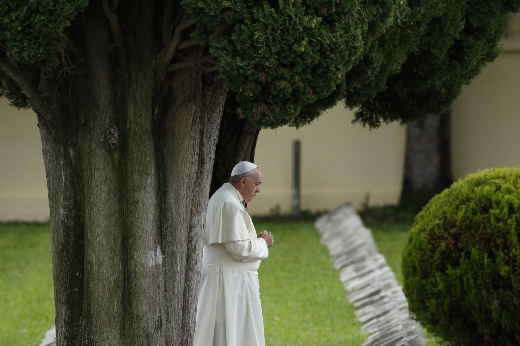 Pope Francis is shown praying at an Austro-Hungarian cemetery for fall soldiers of World War I in Fogliano di Redipuglia, northern Italy, Sept. 13, 2014. The pope in his encyclical "Laudato Si', on Care for Our Common Home," released June 18, said all creation is singing God's praise but people are silencing it. (CNS photo/Paul Haring) See stories slugged ENCYCLICAL- June 18, 2015.
