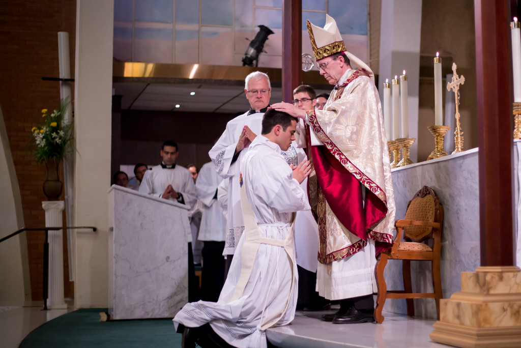 Bishop Thomas J. Olmsted lays hands on Deacon Fernando Camou, ordaining him to the priesthood.