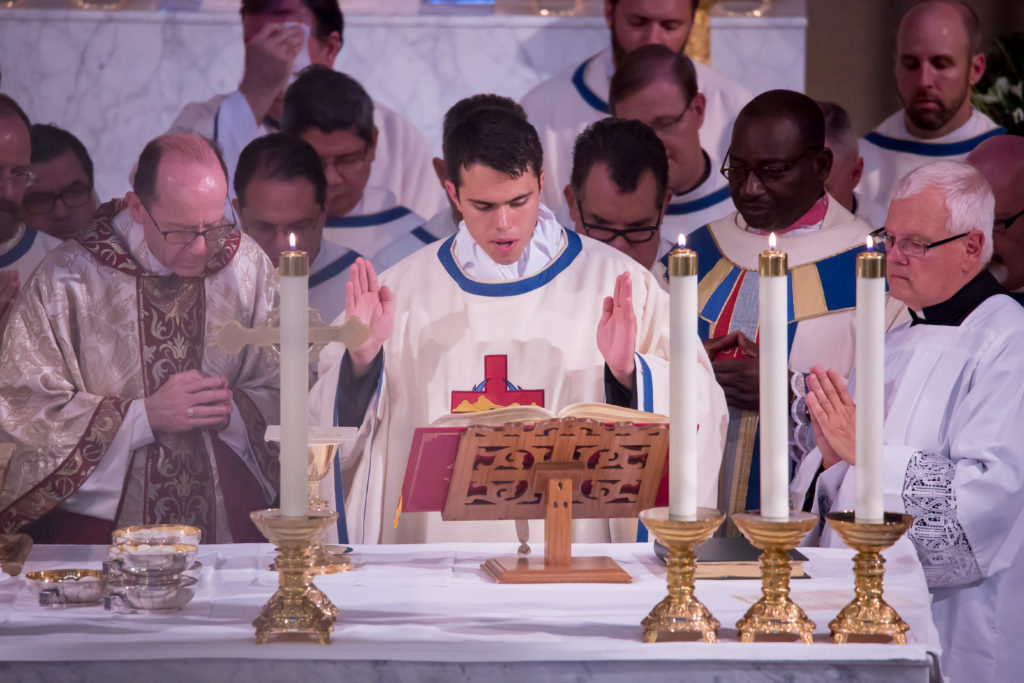 A newly ordained Fr. Fernando Camou offers prayers of consecration over the gifts during his Ordination Mass June 27, 2015, at Ss. Simon and Jude Cathedral. (Ambria Hammel/CATHOLIC SUN)