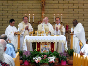 Bishop Thomas J. Olmsted celebrates the Centennial Mass, joined by other priests at the altar. P