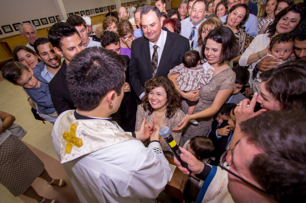 Fr. Fernando Camou blesses his family during the reception after his priest ordination on June 27, 2015, at Ss. Simon and Jude Cathedral. (Billy Hardiman/CATHOLIC SUN)