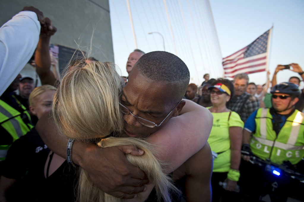 People hug as they gather on the Arthur Ravenel Jr. Bridge in Charleston, S.C., June 21. Thousands gathered on the bridge to show solidarity after nine African-Americans were shot to death by a young white man the evening of June 17 at the city's Emanuel African Methodist Episcopal Church. (CNS photo/Carlo Allegri)