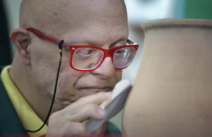 Naji smoothes pottery in late May at Phenix Group Homes, an organization in Beirut that provides residential and day care for people living with intellectual disabilities.  (CNS photo/Paul Jeffrey) 