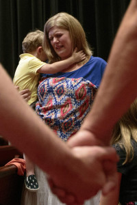 A woman grieves while holding her son during a July 16 prayer vigil at Redemption Point Church in Chattanooga, Tenn., for victims of a deadly shooting spree at two military offices in Chattanooga. The shooter, Mohammad Youssuf Abdulazeez, 24, was killed by police gunfire after he fatally shot four U.S. Marines and wounded three more people at two military offices that day in Chattanooga. (Doug Strickland/CNS via Reuters via Chattanooga Times Free Press)