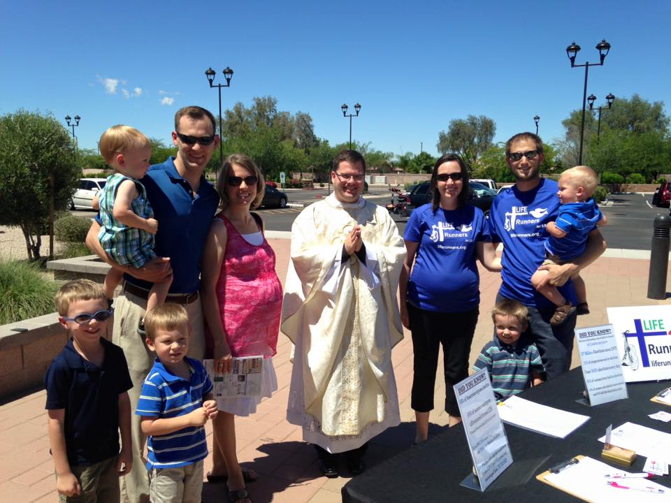 Early members of the LIFE Runners chapter in Gilbert pose with Fr. Chris Axline, chaplain, following a June Mass at St. Mary Magdalene Parish in Gilbert. (courtesy photo)