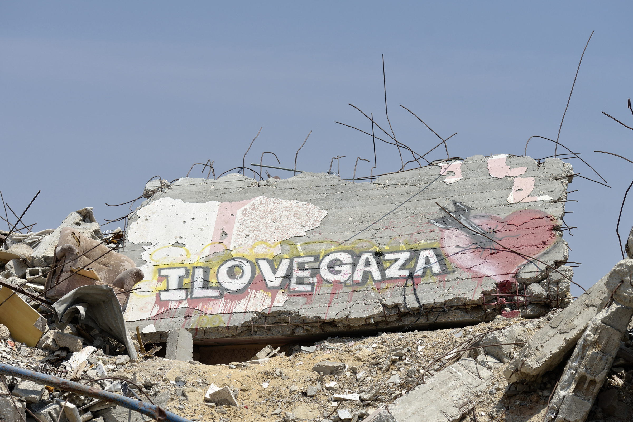 Neighborhood rubble with a message painted on a wall is  seen in Gaza City June 6.  Houses in the area were destroyed during the 2014 war between Israel and the Hamas government of Gaza. (CNS photo/Paul Jeffrey) See GAZA-HOUSING July 17, 2015.