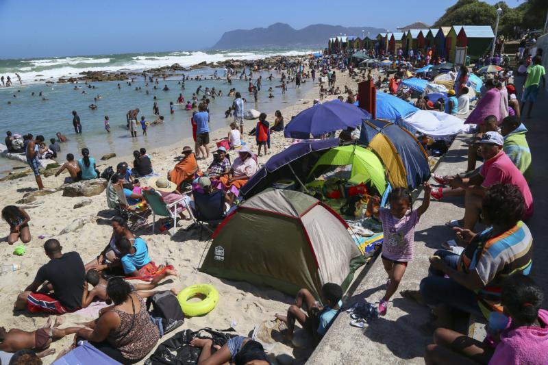 In this 2013 file photo, people spend time on St. James beach in Cape Town, South Africa. (CNS photo/Nic Bothma, EPA) 