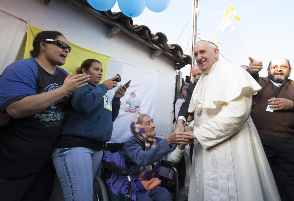 Pope Francis greets an elderly woman as he meets with people of Banado Norte, a poor neighborhood in Asuncion, Paraguay, July 12. (CNS photo/Paul Haring)  See POPE-BANADO July 12, 2015.