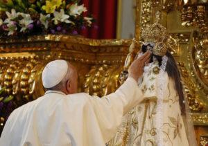 Pope Francis touches a statue of Mary before meeting with clergy, religious men and women, and seminarians at the El Quinche National Marian Shrine in Quito, Ecuador, July 8. (CNS photo/Paul Haring)