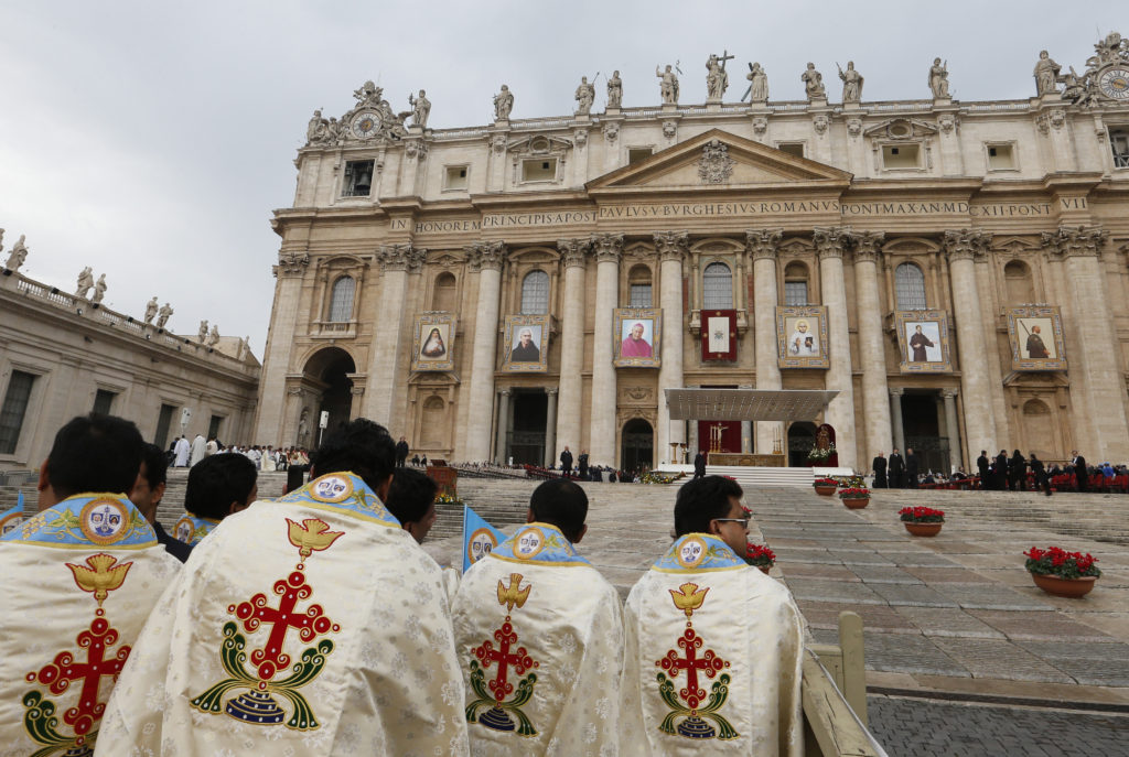 Priests from India wait for the start of the canonization Mass of six new saints celebrated by Pope Francis in St. Peter's Square at the Vatican Nov. 23. The new saints included an Indian Carmelite sister and member of the Syro-Malabar Catholic Church plus the Indian founder of the Carmelites of Mary Immaculate, a Syro-Malabar Catholic order. (CNS photo/Paul Haring)