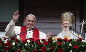 Pope Francis and Ecumenical Patriarch Bartholomew of Constantinople greet a small crowd after delivering a blessing in Istanbul Nov. 30. (CNS photo/Paul Haring) 