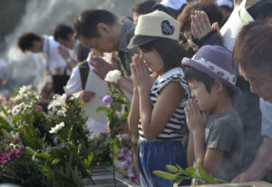 People pray at a memorial in Hiroshima, Japan, Aug. 6, to commemorate the victims of the atomic bombing of the city by the United States in 1945. Delegation members from the World Council of Churches, in Hiroshima for the commemoration, said they would return home to build a movement to rid the world of nuclear weapons. (CNS photo/Paul Jeffrey)