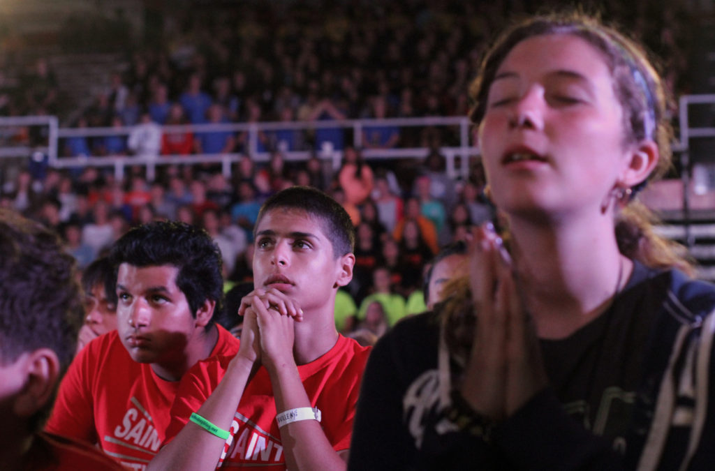 Participants pray during eucharistic adoration Aug. 8 at the Steubenville NYC youth conference at St. John's University in the Jamaica section of the New York borough of Queens. More than 1.800 teenagers attended the Aug. 7-9 event. (CNS photo/Gregory A. Shemitz)