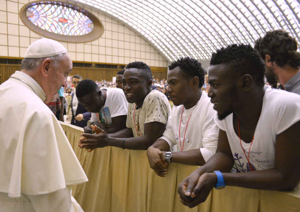 Pope Francis meets a group of Nigerian refugees at the Vatican Aug. 12. The pope will address the U.S. Congress and the U.N. General Assembly during his September U.S. visit and will discuss the idea of one human family and shared responsibility for others and the world. (CNS photo/L'Osservatore Romano via Reuters)