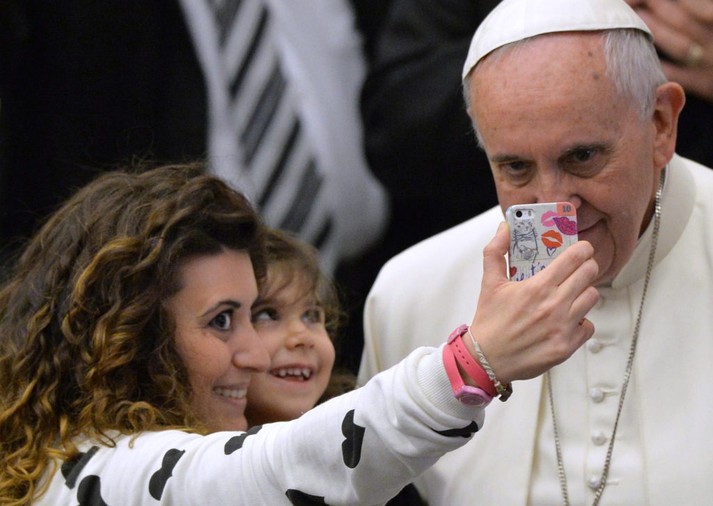 Pope Francis poses for a selfie with faithful at the Vatican Jan. 21. The Vatican's U.N. representative said everyone wants a selfie with the pope. (CNS photo/Maurizio Brambatti, EPA)