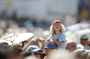 A child watches as Pope Francis leads the Angelus from the window of his studio overlooking St. Peter's Square at the Vatican Aug. 30. (CNS photo/Max Rossi, Reuters) 