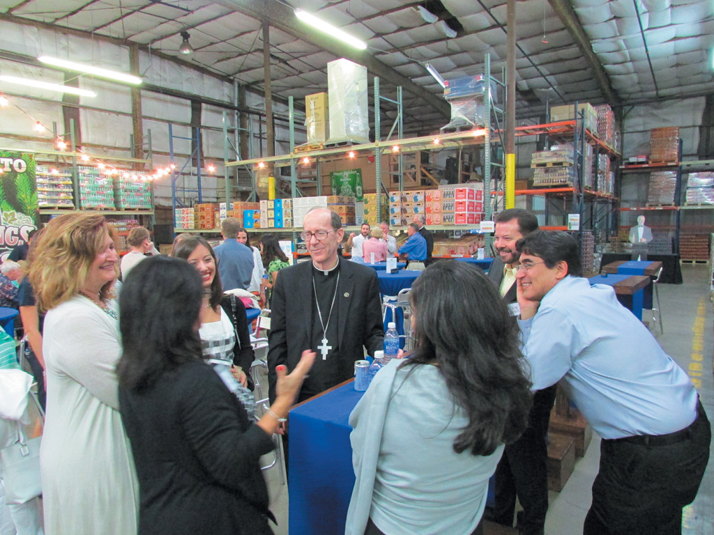 Bishop Olmsted interacts with Catholics from the North Deanery at the Nackard Beverage Warehouse in Flagstaff during the Aug. 8 “Blessings and Beers” reception. (Courtesy of the Catholic Community Foundation)