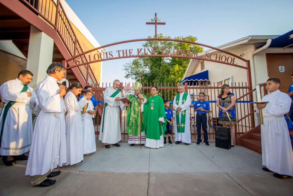 Auxiliary Bishop Eduardo A. Nevares blesses the entrance gate during the 50 year anniversary celebration at St. Louis the King Catholic School on August 15. (Billy Hardiman/CATHOLIC SUN)