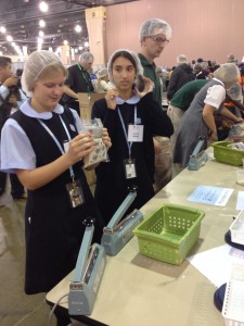 Lacey Powers helps package 200,000 meals to families in West Africa. (Gina Keating/CATHOLIC SUN)