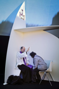 A priest blesses a woman as he hears confession during a 2013 outdoor Mass in Madrid. Pope Francis has issued a letter offering a series of instances in which absolution can be granted during the Year of Mercy. (CNS photo/Emilio Naranjo, EPA)