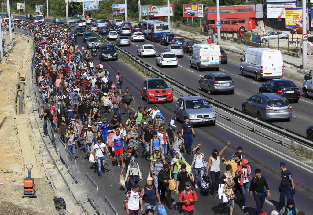 Migrants walk along a highway in Bicske, Hungary, near the border with Austria Sept. 4.  (CNS/Bernadett Szabo, Reuters) 