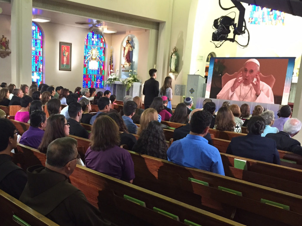 Members of Sacred Heart Church in McAllen, Texas, participate in a virtual town hall meeting with Pope Francis via satellite link from the Vatican Aug. 31. The meeting also included Catholics from Chicago and Los Angeles and was arranged and hosted by ABC News. (CNS photo/courtesy of ABC News) 