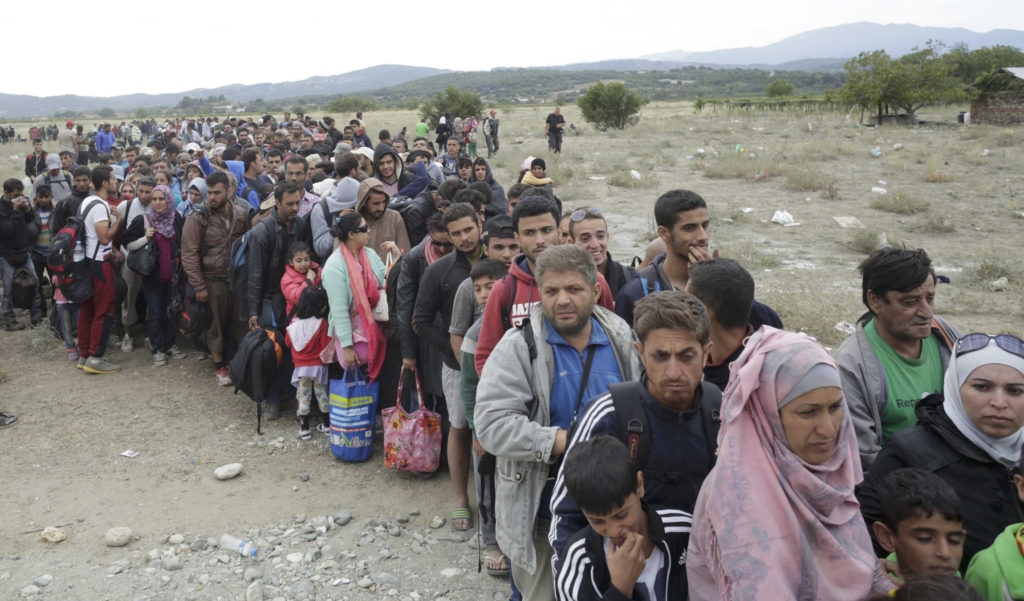 Hundreds of migrants line up to catch a train near Gevgelija, Macedonia, Sept. 7. (CNS photo/Stoyan Nenov, Reuters) 