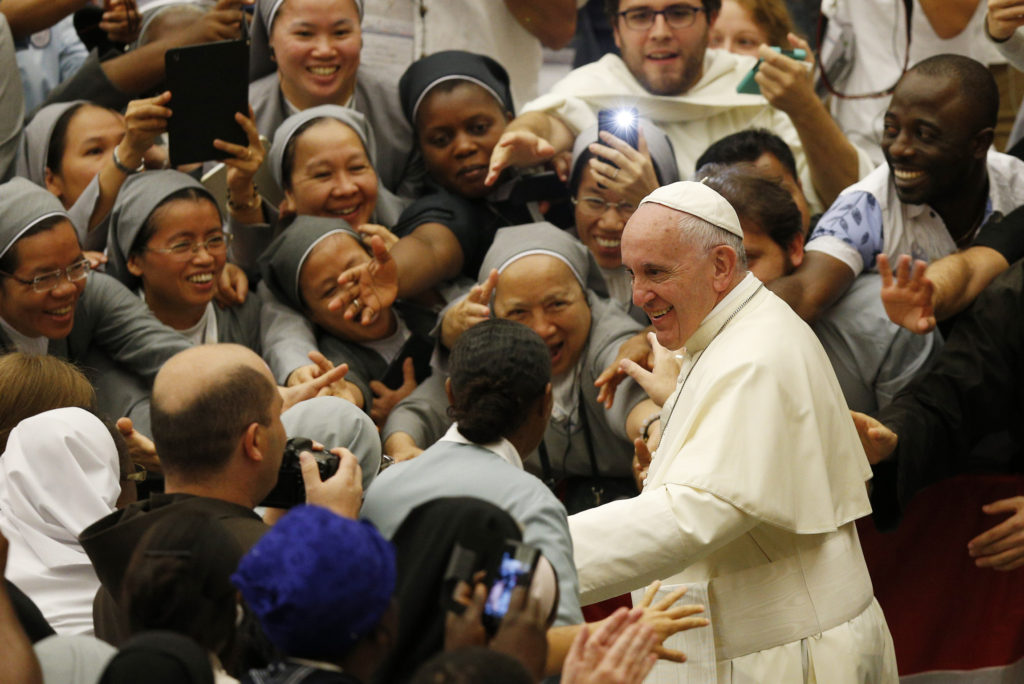 Pope Francis leaves an audience with religious from around the world in Paul VI hall at the Vatican Sept. 17. The pope praised women religious for always heading to the "front lines" to bring the church's tenderness and motherly love to those most in need. (CNS photo/Paul Haring) 