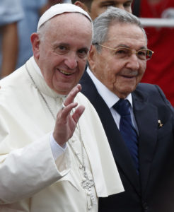 Pope Francis waves as he walks with Cuban President Raul Castro at Jose Marti International Airport in Havana Sept. 19. (CNS photo/Paul Haring)