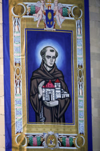 A tapestry featuring an image of Blessed Junipero Serra hangs outside the Basilica of the National Shrine of the Immaculate Conception before Pope Francis arrives for Mass and the canonization of the Spanish missionary Sept. 23 in Washington. (CNS photo/Bob Roller)