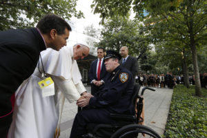 Pope Francis greets a New York City police officer as he visits the ground zero 9/11 Memorial in New York Sept. 25. (CNS photo/Paul Haring)