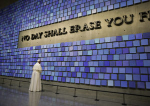 Pope Francis pauses in front of a display at the National 9/11 Memorial and Museum in New York Sept. 25. The Virgil quotation on the wall reads, "No day shall erase you from the memory of time." (CNS photo/Paul Haring)